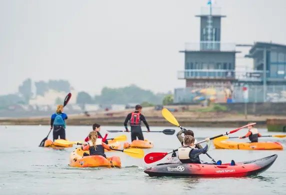 A group of kayakers on the water at the Andrew Simpson Watersports Centre, Portsmouth