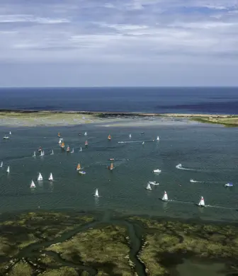 An aerial view of lots of boats sailing on the water from Blakeney Sailing Club, North Norfolk
