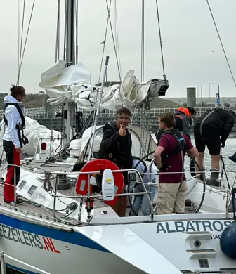 Men aboard the yacht Albatros from Dutch Offshore Sailing Academy, Zeezeilers preparing the boat to sail