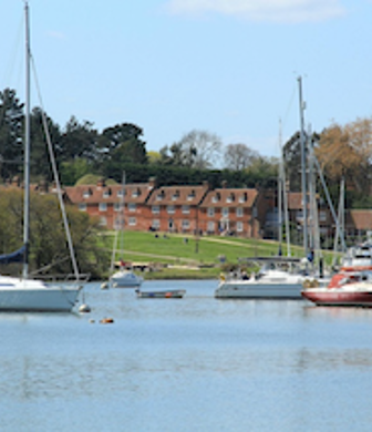 Universal Sailing School as seen from the water with boats moored in front