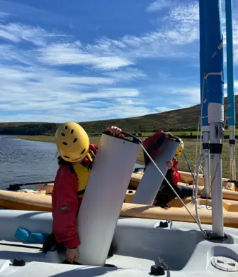 Children putting dagger boards into Pico dinghies  at Whiteadder Reservoir