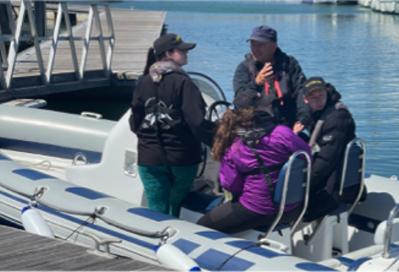 Students being instructed on a powerboat course