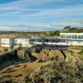 The club house at South Caernarvonshire Yacht Club, Abersoch, Wales taken by a drone showing the surrounding hills and countryside and the coast at Cardigan Bay