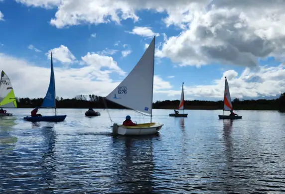 A variety of dinghies sailing on the water