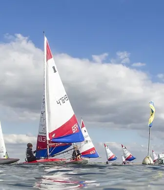 A close up of young people sailing dinghies at Queen Mary Sailing Club, Ashford