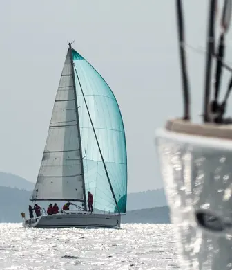 A yacht sailing with a turquoise spinnaker from Center of Sailing - Centar Jedrenja, Croatia