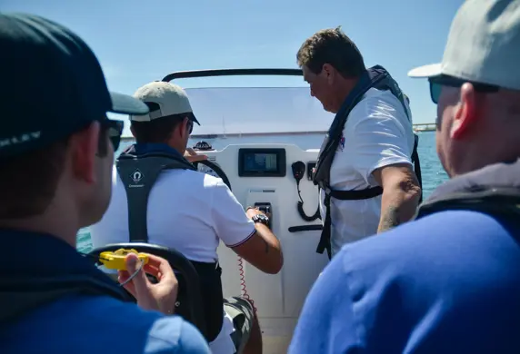 Four men on a powerboat