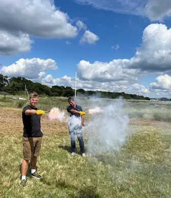 Two men demonstrating use of flares