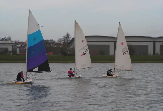 Three dinghies sailing on the Grimsbury Reservoir at Banbury Cross Sailing Club