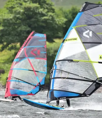 Two windsurfers on the water at Watergrove Windsurfing Club, Watergrove Reservoir, Rochdale