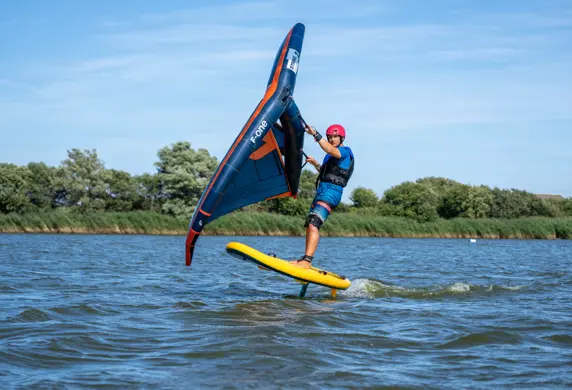 A kite surfer gliding across the water