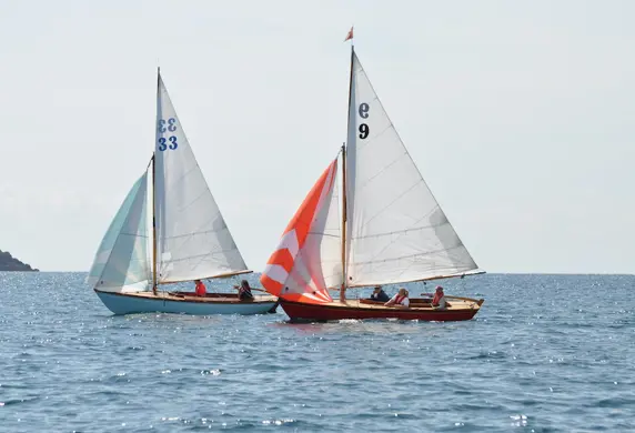 Two Seabird classic sail boats on the water on a clear day at South Caernarvonshire Yacht Club, Abersoch, Wales