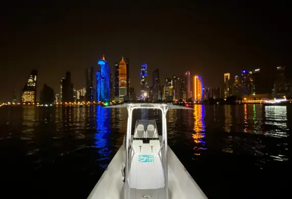 The Port of Doha at night, very colourfully lit up taken from a powerboat at Boxbay Boat Club, Old Doha Port, State of Qatar