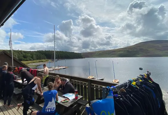 View across Whiteadder Reservoir showing people following a training session in Pico dinghies