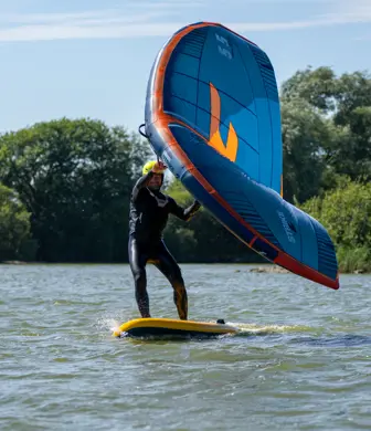 A kite surfer gliding across the water