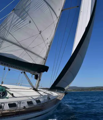 A yacht sailing on the water with 2 sails up