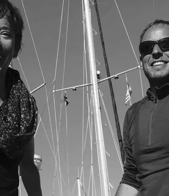 A happy couple stowing their yacht in black and white
