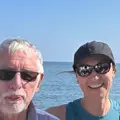 Head shot of 3 skippers with a lighthouse in the background