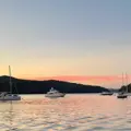 Boats and yachts moored at sunset