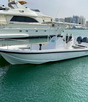 A large powerboat moored alongside the jetty with a superyacht moored behind it at the Boxbay Boat Club, Old Doha Port, State of Qatar