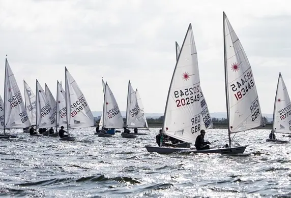 A large group of RS sail boats racing on the reservoir at Queen Mary Sailing Club, Ashford