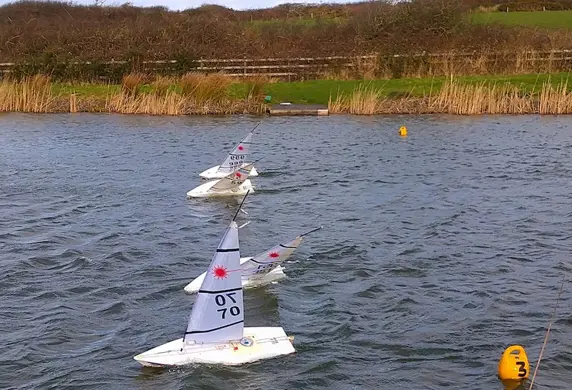 Four remote controlled Laser dinghies on the water at South Caernarvonshire Yacht Club, Abersoch, Wales