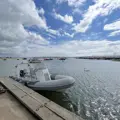 A rib moored alongside a pontoon