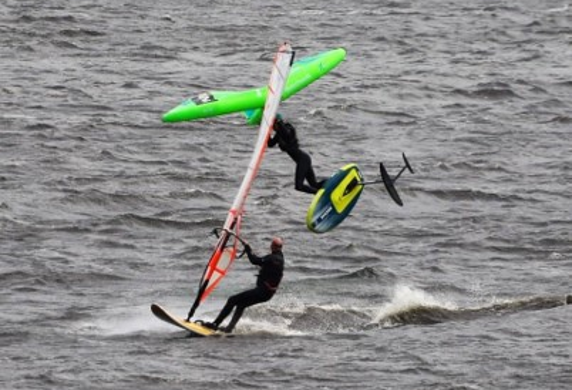 A windsurfer and a wing foiler on the water at Derwent Reservoir Sailing Club, Consett, County Durham