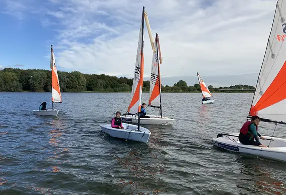 A group of sailing dinghies on the reservoir at the Royal Hospital School Sailing Academy, Ipswich on a sunny day