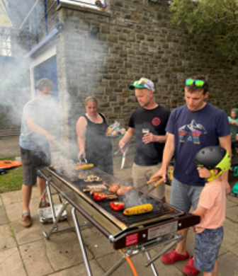 A group of members enjoying a very smoky BBQ at Derwent Reservoir Sailing Club, Consett, County Durham